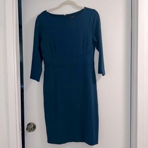 Boat neck, long sleeved, lined back slit dress.
